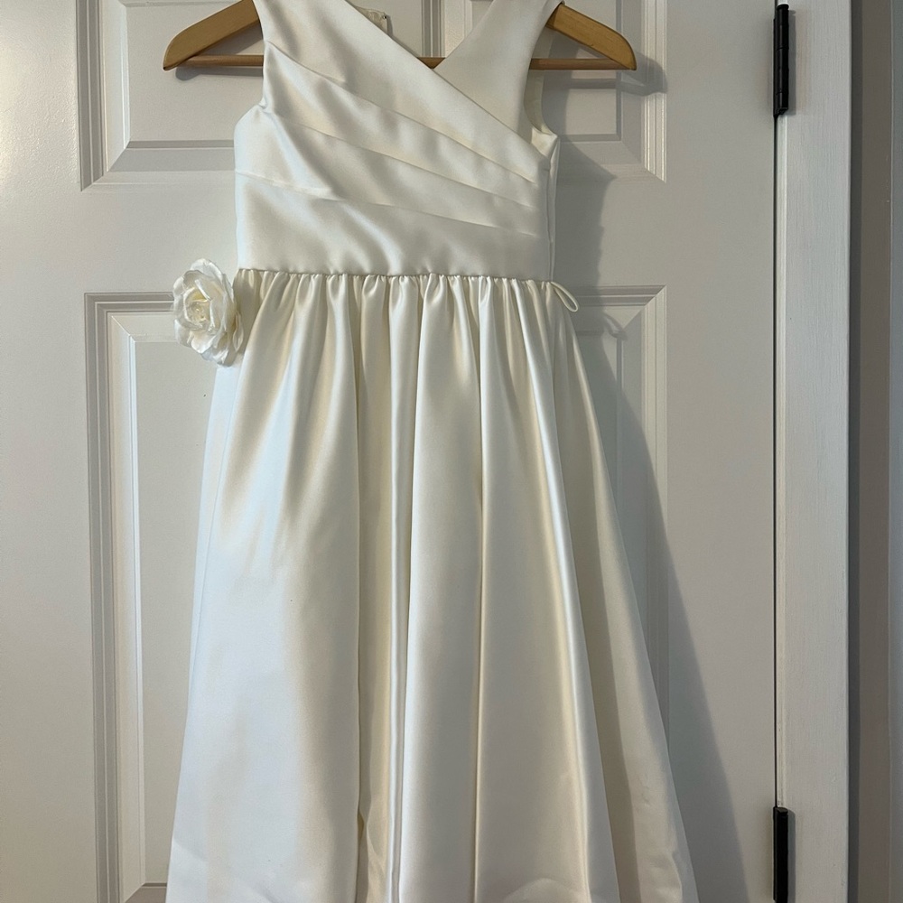 Ivory dress with adjustable beige bow/belt and floral accent.